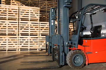 Fototapeta na wymiar Forklift in a large warehouse for vegetable storage