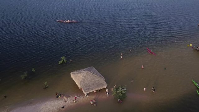 Aerial drone view of beautiful beach, bars, boats, bathers vacation tourists in Alter do Chao on the Tapajos river bank in the Amazon rainforest. Concept of leisure, environment, travel and vacation4K