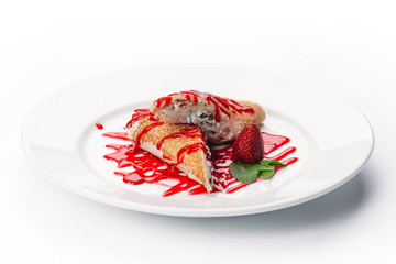 dessert of pancakes, ice cream, and fruit on a white background