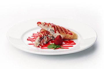 dessert of pancakes, ice cream, and fruit on a white background