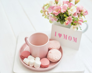 Mother's Day Greeting Card. Romantic breakfast. Happy mothers day frame background. Tea set with flowers and sweet. Spring card template. Happy Birthday or Valentine. Women's Day. Copy space.