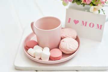 Mother's Day Greeting Card. Romantic breakfast. Happy mothers day frame background. Tea set with flowers and sweet. Spring card template. Happy Birthday or Valentine. Women's Day. Copy space.
