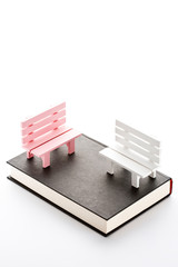 Bench and book in front of a white background.