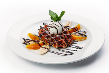 dessert of pancakes, ice cream, and fruit on a white background