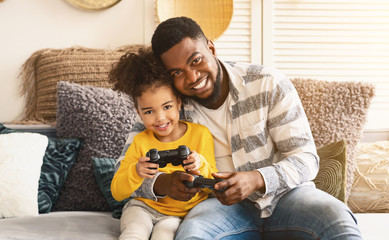 African american family gamers playing on console © Prostock-studio