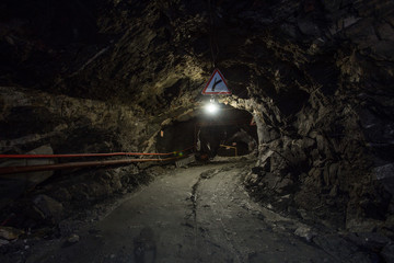 Underground gold quartz mine shaft tunnel drift with light
