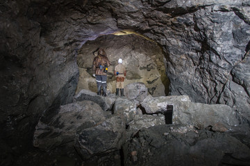 Miners in underground gold quartz mine tunnel