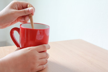 Woman hands holding red mug of hot tea in morning.Drink Tea relax cozy day. happy concept.