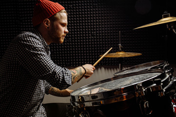handsome talented guy play on drums, caucasian young man keen on music, preparing for concert, rock...