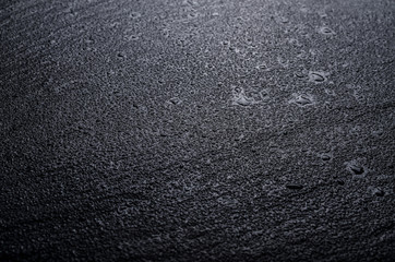 Wet slate stone dark background top view