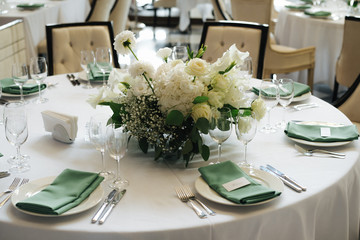 wedding table decoration with green elements and flowers