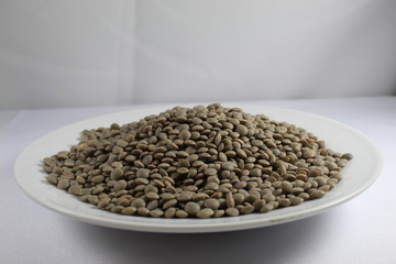 Lentils in bowl on white background