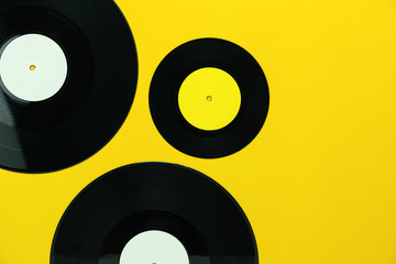 Table Top view of musical instrument retro concept.Flat lay objects of the many music disk on modern rustic yellow paper at home office desk.copy space for creative design text and word.