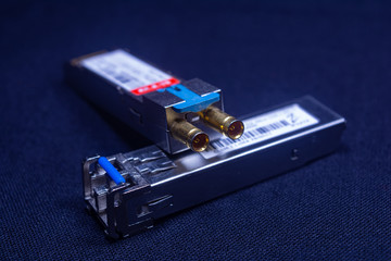 TWO OFC SFP SMALL FORM FACTOR PLUGGABLE ARE PLACED ON A BLACK BACKGROUND TELE COMMUNICATION 1