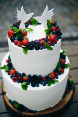 white cake with berries