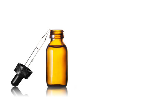 Serum or Essential oil in brown glass bottle on white background
