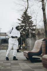 Cleaning and Disinfection at town complex amid the coronavirus epidemic Professional teams for disinfection efforts Infection prevention and control of epidemic Protective suit and mask