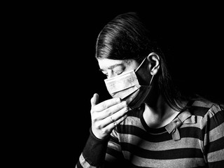 Woman with surgical mask sneezing or coughing. Pandemic or epidemic and scary, fear or danger concept. Protection for biohazard like COVID-19 aka Coronavirus. Black Background. Black and White
