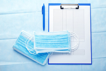Doctor appointment. Medical test forms documents and medical masks, Surgical protection mask on blue background. Concept medicine health care, virosology. Coronovirus Covid-19 prevention