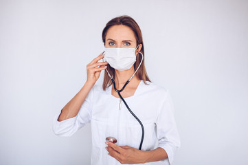 Woman doctor nurse wearing protective mask and stethoscope for check breathing, corona virus prevention, hygiene to stop spreading coronavirus. Avoid contaminating Corona virus Covid-19 concept