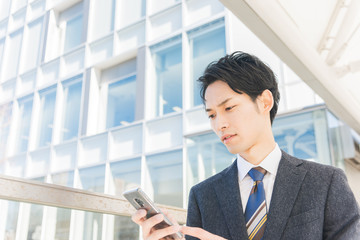 スマートフォンを手に持つビジネスマン