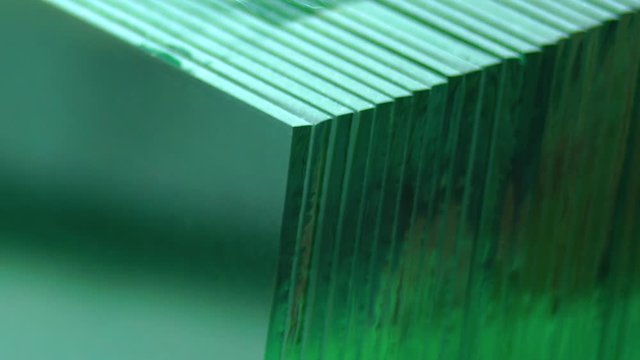 Clip of close up on a pile of glass in a factory. Closeup of slabs, sheets of glass