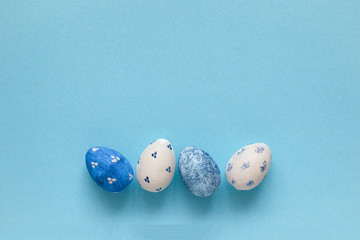 Happy Easter card. White frame with white and blue speckled easter eggs with copy space for text.