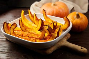 Slices of baked pumpkin in white ceramic bowl