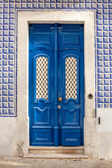 Blue antique door closed, typical Portuguese.