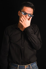Fototapeta premium Handsome young man in black shirt keeping arms crossed wear glasses on black background , Asia Portrait