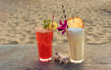 drinks with blur beach and sunset in background