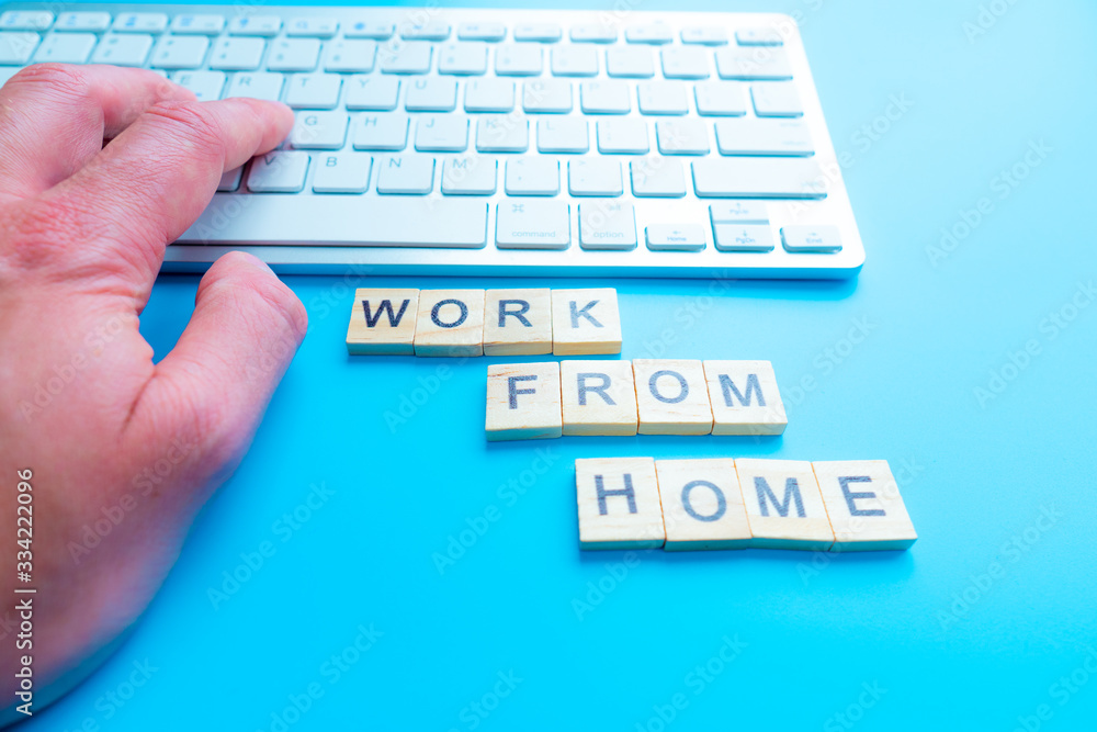 Poster work from home, message concept written post it on laptop keyboard.