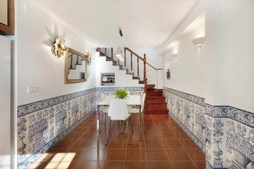 Home interior, modern contemporary furniture room. Access wooden stairs to upper floor. Tiles.