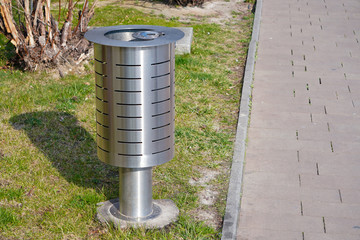 metal urn for mixed garbage and cigarette butts on the street of the city. separate collection of waste