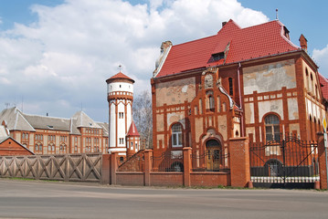 Fototapeta premium Former infantry barracks and a water tower on the territory of a military town. Baltiysk, Kaliningrad region