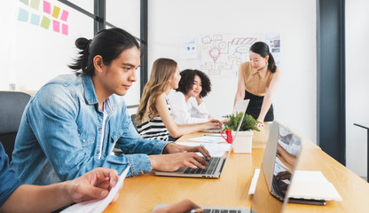 Asian business people working with laptop, searching data for business startup plan and strategy