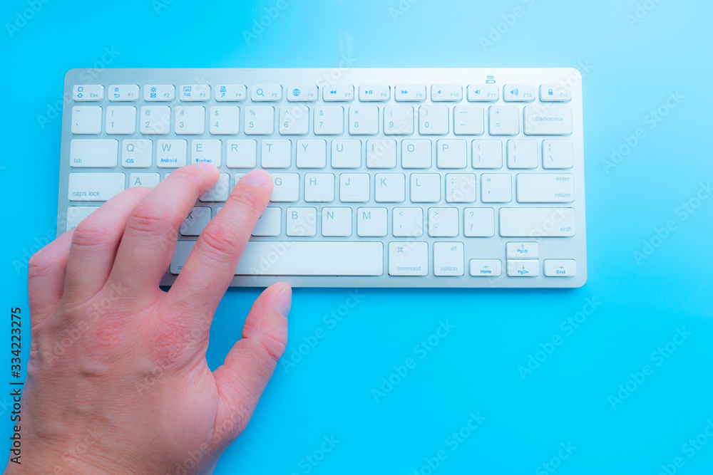 Poster working at home with computer man writing a blog. man hands on the keyboard