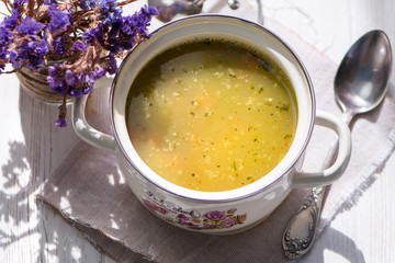 pea soup on chicken broth in pan on wooden background