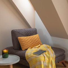 Cozy nook by the window with yellow blanket and pillow on a coach - obrazy, fototapety, plakaty