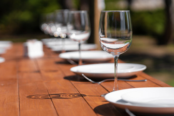 Served wooden table without a tablecloth. Cafe in the open air park