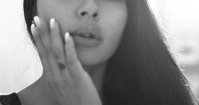 Portrait of beauty brunette woman in black lingerie posing on the bed - black and white video in slow motion