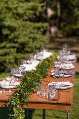 Preparing for an open-air party. Decorated with fresh flowers served tables. Table number. Decoration Details