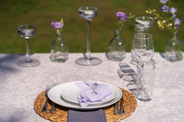 The festive table is served and decorated with fresh flowers. Details of festive decorations with fresh flowers