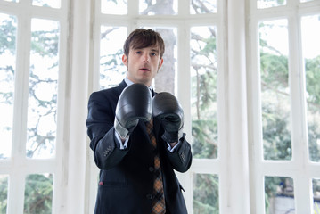 man in a suit with boxing gloves