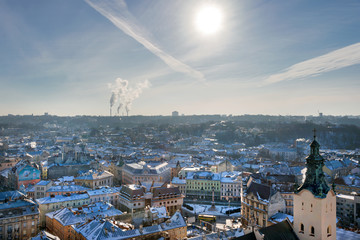Obraz premium Winter panorama view from the Town Hall on the downtown in Lviv, Ukraine. Old buildings. Roofs covered with snow.