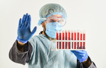Scientist test tubes with blood samples. Coronavirus vaccine. Doctor protective mask. Laboratory...