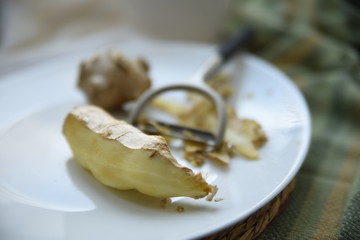 Preparing a sweet hot drink with ginger, lemon and honey for easing cold symptoms and feeling better  M