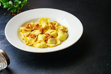 tortellini, pasta with filling (ravioli or dumplings) second course Menu concept. food background. top view copy space for text