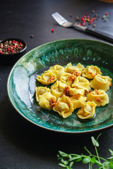 tortellini, pasta with filling (ravioli or dumplings) second course Menu concept. food background. top view copy space for text
