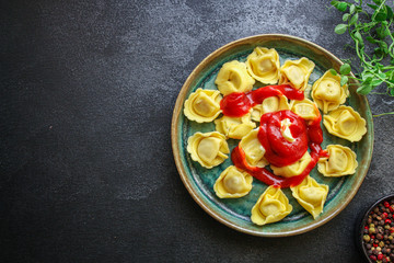 tortellini, pasta with filling (ravioli or dumplings) second course Menu concept. food background. top view copy space for text
